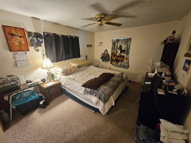 bedroom with a textured ceiling, carpet flooring, and ceiling fan