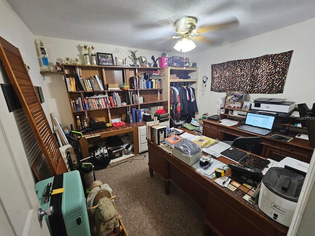 home office featuring a textured ceiling, carpet flooring, and ceiling fan