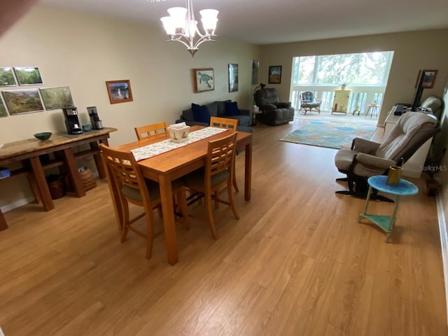 dining space with a chandelier and light wood-type flooring