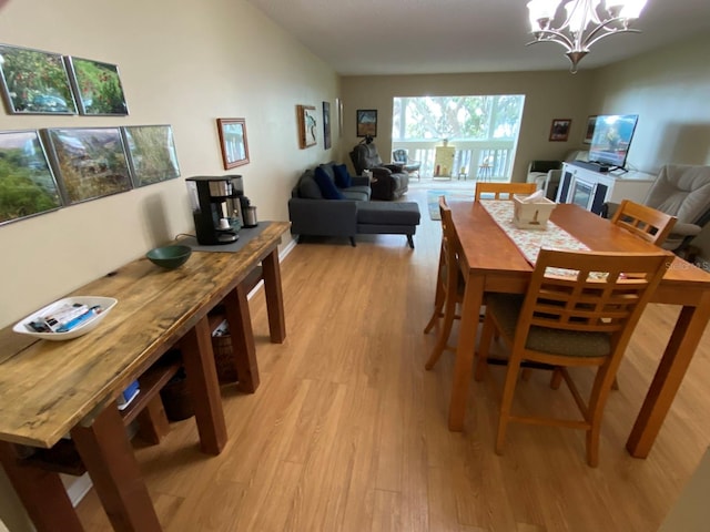 dining area featuring a chandelier and light wood-type flooring