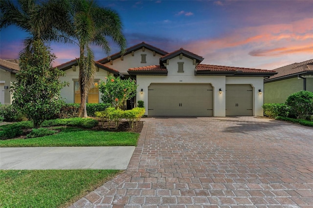 mediterranean / spanish-style house with a garage