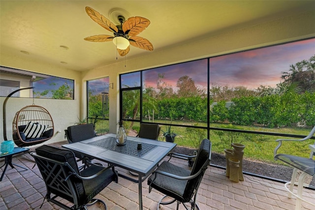 sunroom / solarium featuring ceiling fan