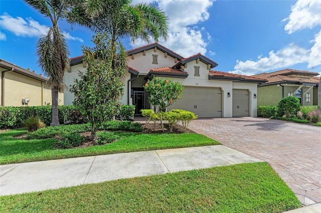 mediterranean / spanish-style home with a front lawn and a garage