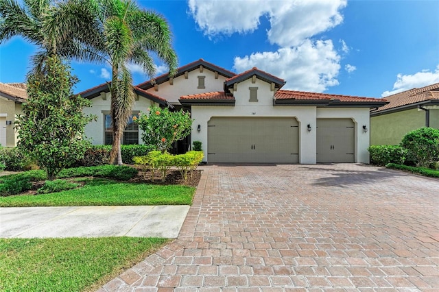 mediterranean / spanish house with a garage