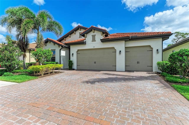 mediterranean / spanish-style home with a garage