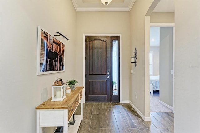 entryway featuring ornamental molding and dark wood-type flooring