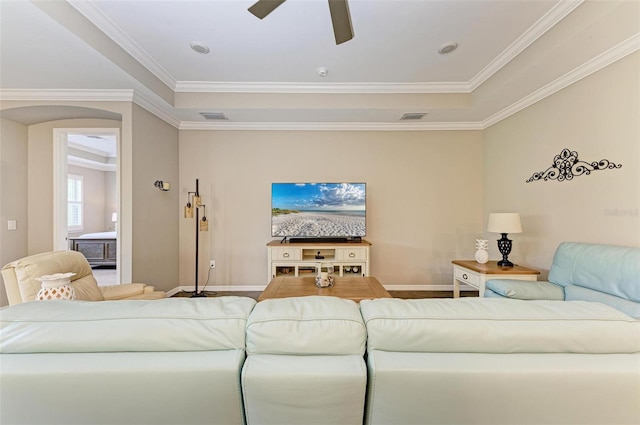 living room featuring ceiling fan and ornamental molding