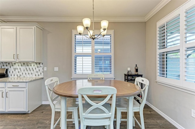 dining space featuring dark wood-type flooring, crown molding, and a notable chandelier