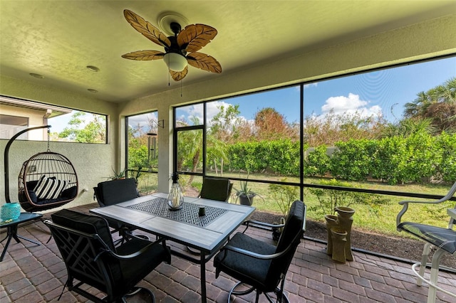 sunroom / solarium featuring ceiling fan