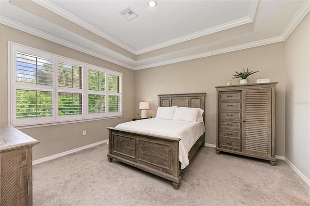 carpeted bedroom featuring ornamental molding and a raised ceiling