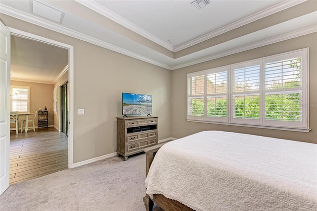 bedroom featuring hardwood / wood-style flooring, ornamental molding, and multiple windows