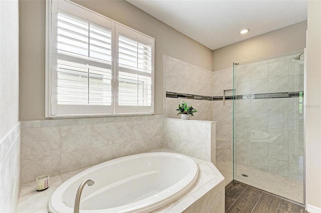 bathroom featuring hardwood / wood-style flooring and independent shower and bath