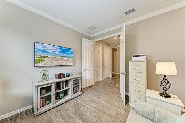 sitting room featuring light hardwood / wood-style flooring and crown molding