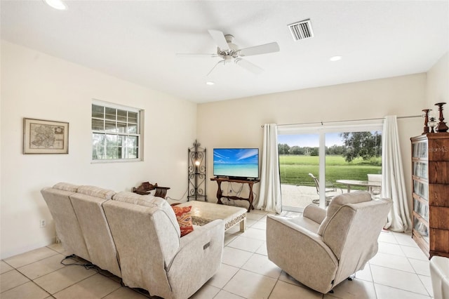 living room featuring light tile patterned flooring and ceiling fan