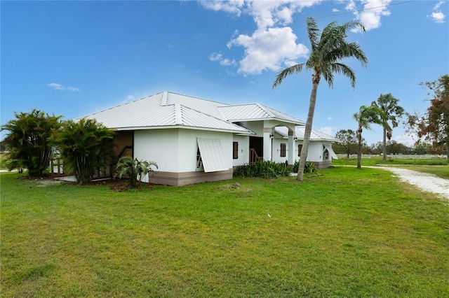 view of side of property with a yard