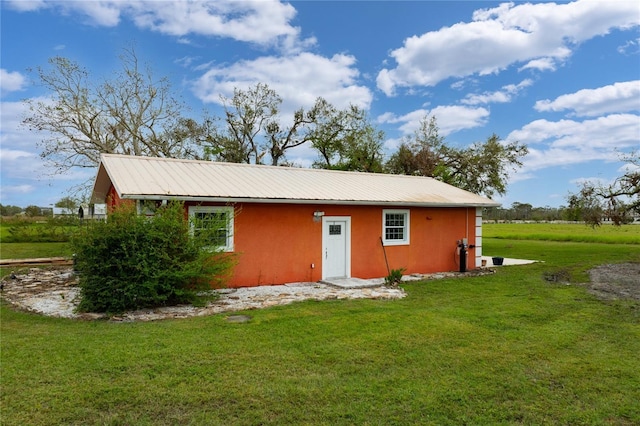 back of house with a yard