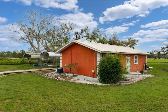 view of home's exterior with cooling unit, a lawn, and a carport