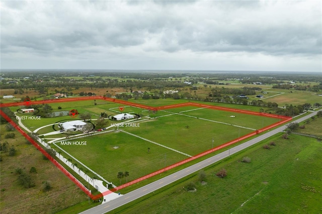 birds eye view of property with a rural view