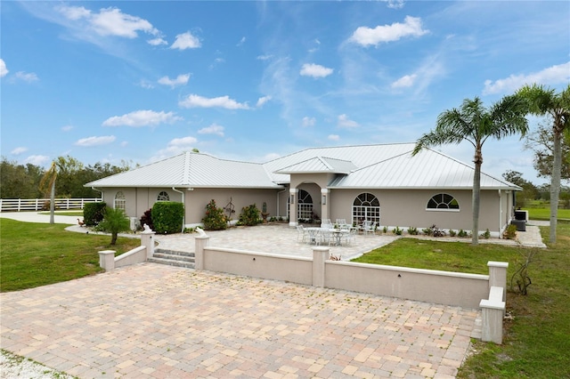 single story home with a patio area and a front lawn