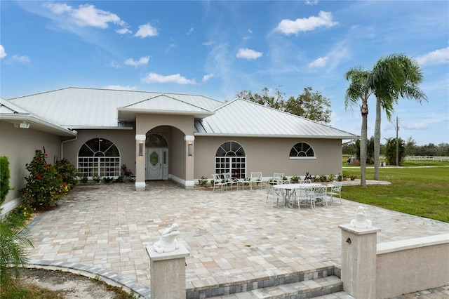 rear view of house with a yard and a patio area