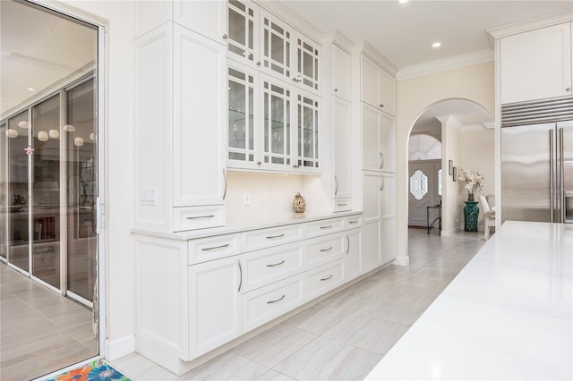 corridor featuring light tile patterned floors and ornamental molding