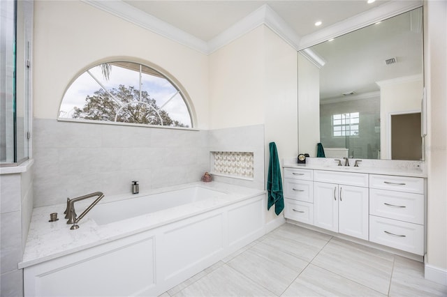 bathroom featuring vanity, plenty of natural light, a bath, and tile patterned floors