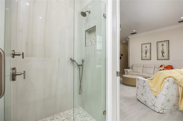 bathroom with crown molding and walk in shower