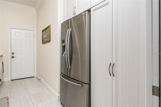 kitchen featuring stainless steel refrigerator with ice dispenser, crown molding, light tile patterned floors, and white cabinets