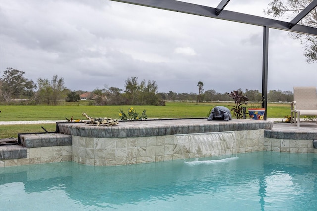 view of swimming pool featuring a lanai and a lawn