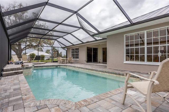 view of pool with a patio and a lanai