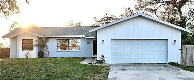 ranch-style house featuring a garage and a front yard