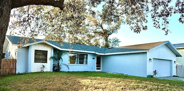 single story home with a garage and a front yard