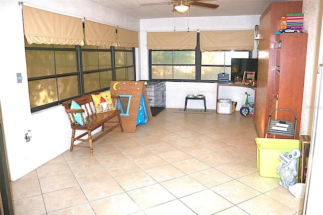 sunroom featuring ceiling fan