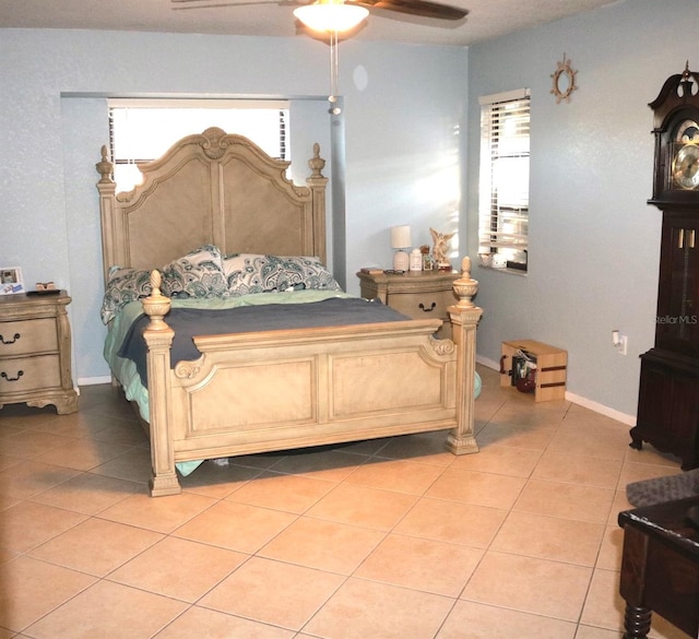 tiled bedroom featuring ceiling fan