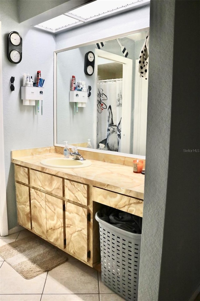 bathroom with tile patterned flooring and vanity