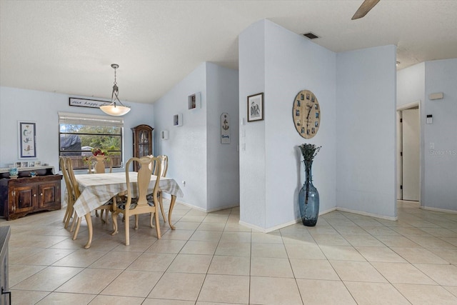 dining space featuring visible vents, a textured ceiling, and light tile patterned flooring