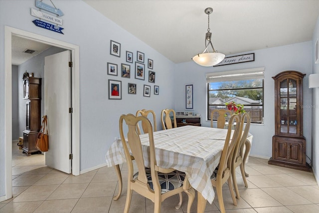 dining space with light tile patterned flooring, visible vents, and baseboards