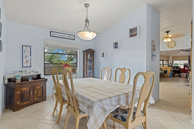 dining space featuring ceiling fan, baseboards, a textured ceiling, and light tile patterned flooring