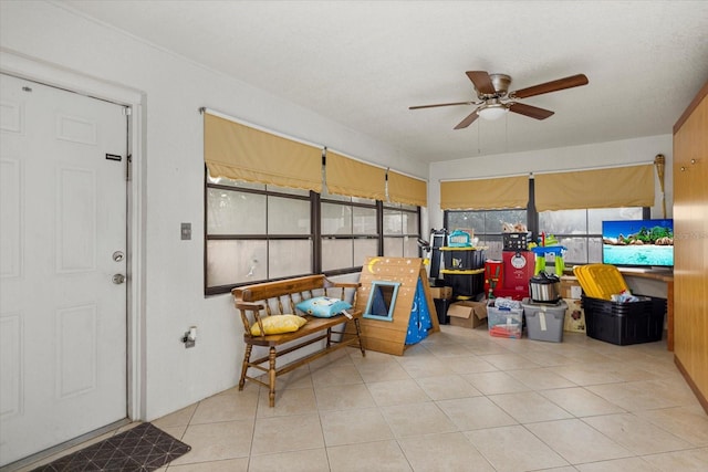 interior space with ceiling fan