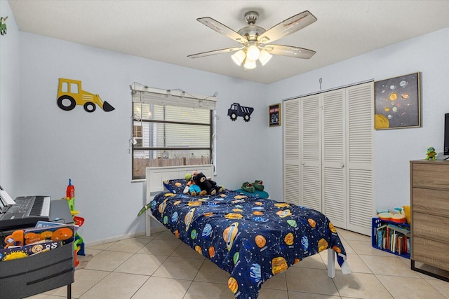 bedroom with tile patterned flooring, a closet, and ceiling fan