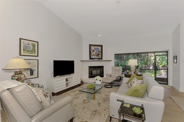 living room featuring lofted ceiling and light wood-type flooring