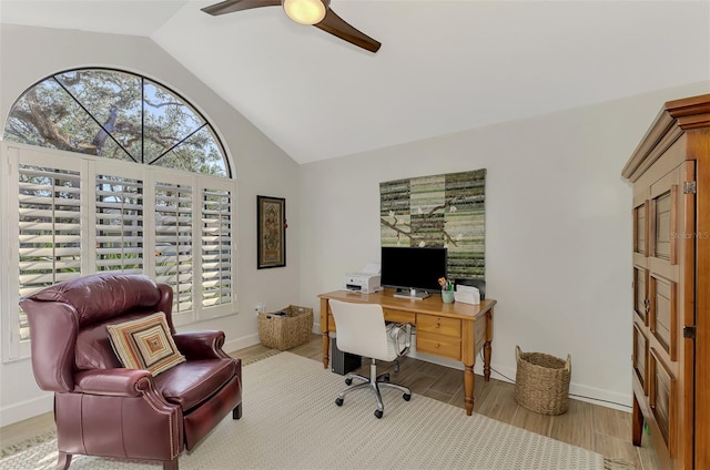 home office featuring high vaulted ceiling, light wood-type flooring, and ceiling fan