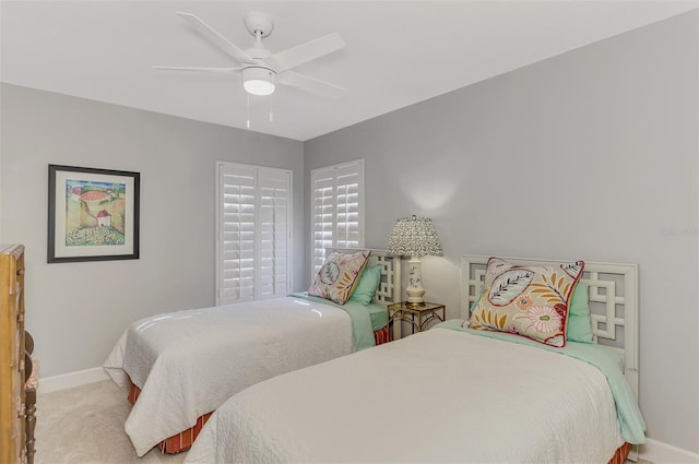 bedroom with ceiling fan and light carpet