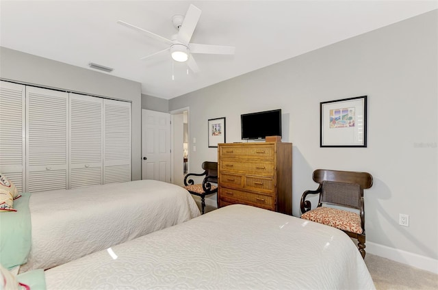 bedroom with a closet, ceiling fan, and carpet flooring