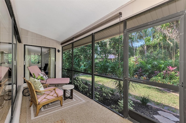 sunroom / solarium featuring vaulted ceiling