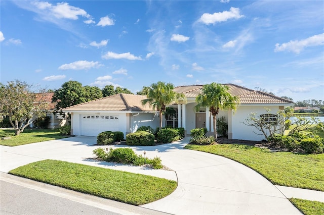 mediterranean / spanish-style home with a front yard and a garage