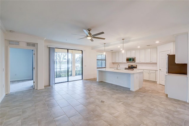 kitchen with ceiling fan, sink, a center island with sink, white cabinets, and appliances with stainless steel finishes