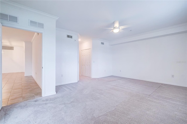 carpeted spare room featuring ceiling fan and ornamental molding