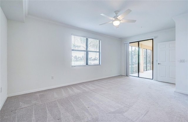 unfurnished room with plenty of natural light, light colored carpet, and crown molding