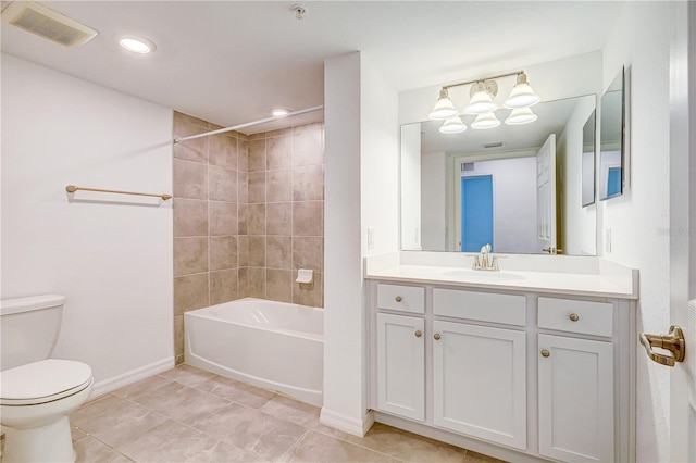 full bathroom with tile patterned flooring, vanity, toilet, and tiled shower / bath